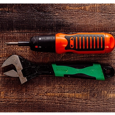 Power Screwdriver screwing a screw in a window frame