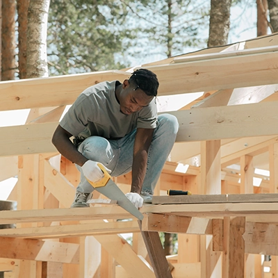 Hand Tool Safety Basics for New DIYers (Safety First – Always) 5 Man sawing on a roof